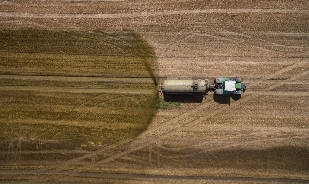 Aerial view of tractor fertilising field