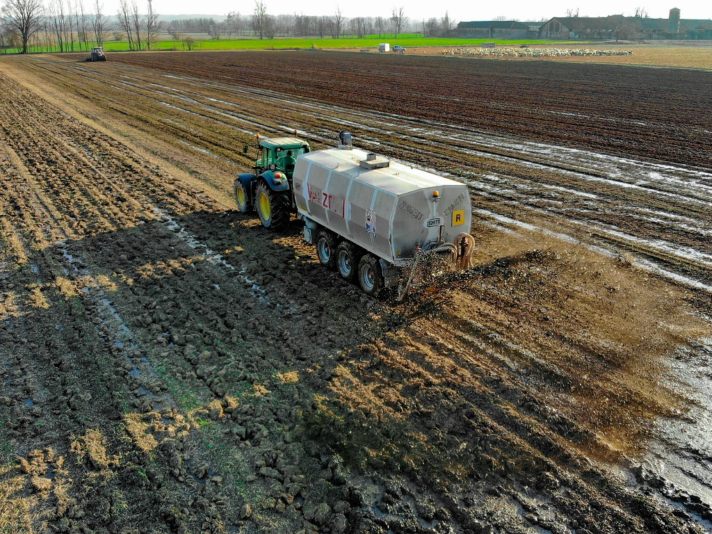Tractor spreading manure on fields